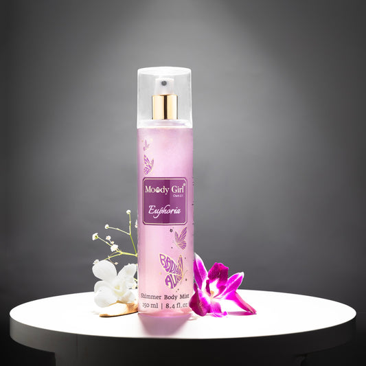 Pink body mist bottle with floral decorations on a dark background