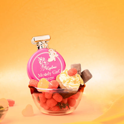Zealous 100ml Pink 'Moody Girl' perfume bottle with a cupcake and berries on an orange background