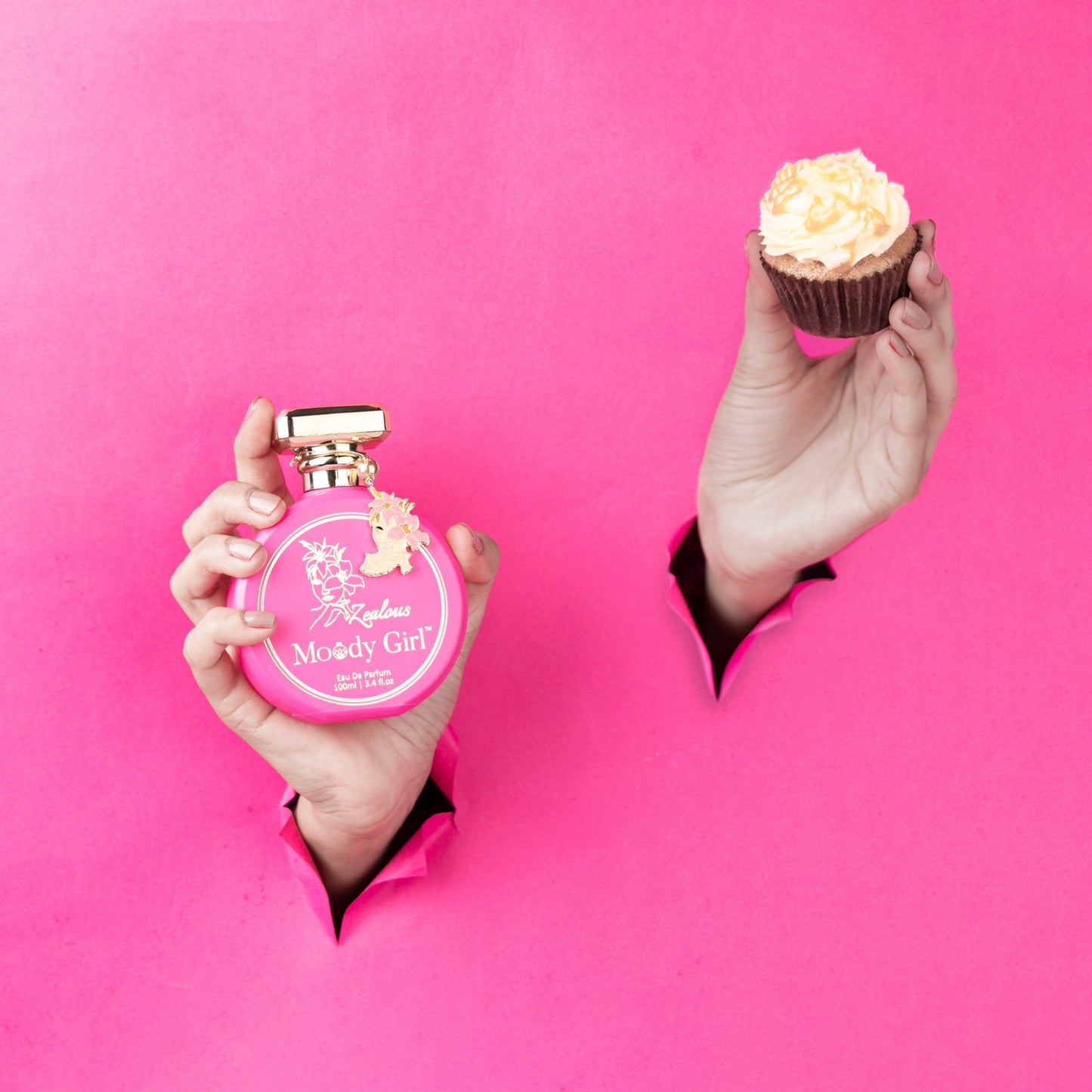 Zealous 100ml Pink 'Moody Girl' perfume bottle and cupcake held against a pink background